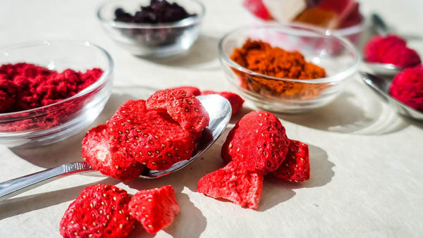 all products collection image with organic dried berries and organic berry powders on a wooden table