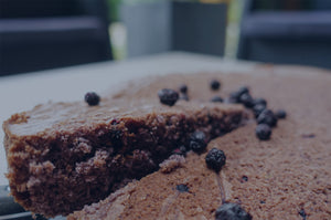 Harctic Superfoods a slice of blueberry olive oil cake being cut on a plate